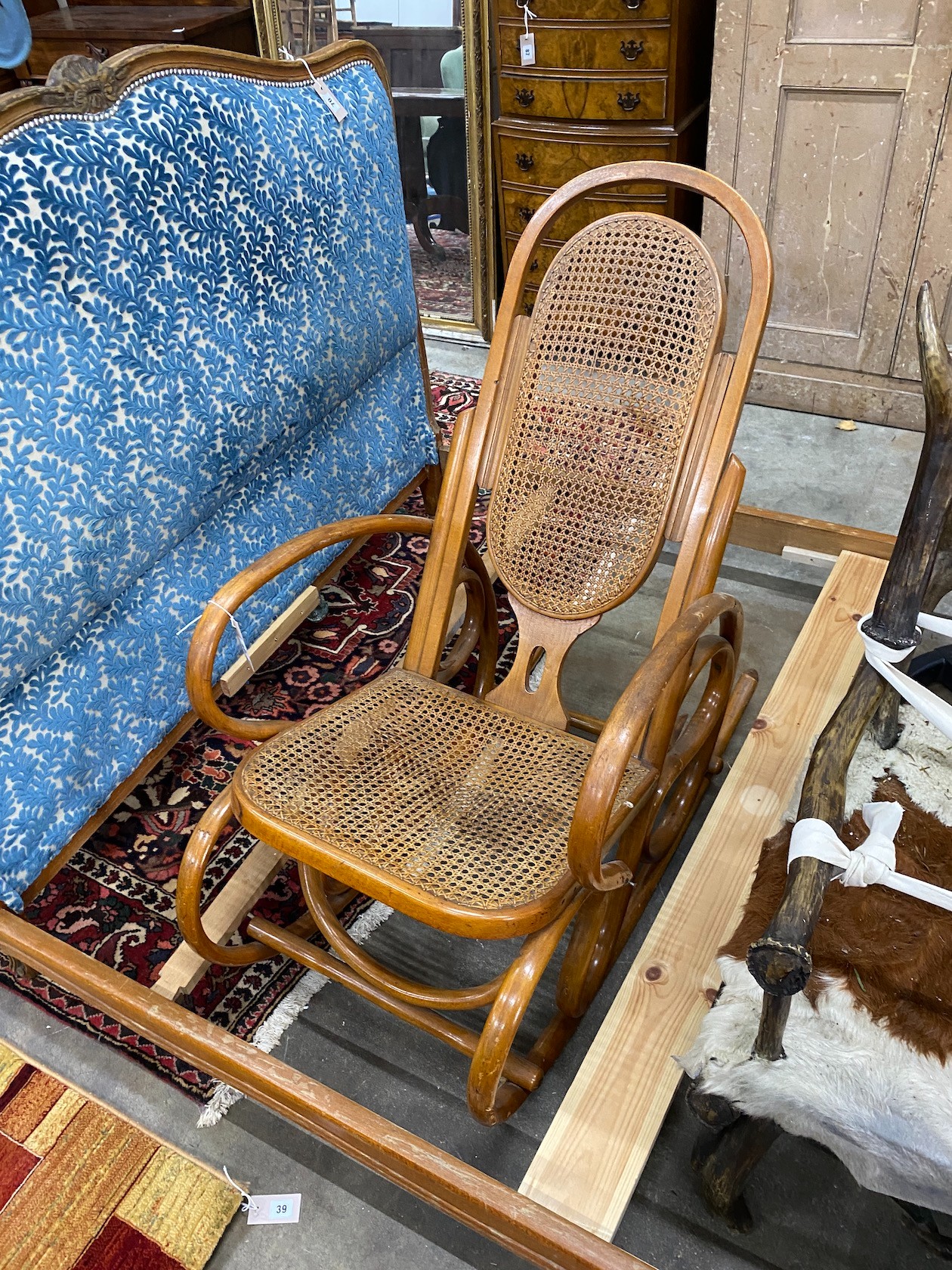 A caned bentwood rocking chair, width 57cm, depth 116cm, height 116cm
